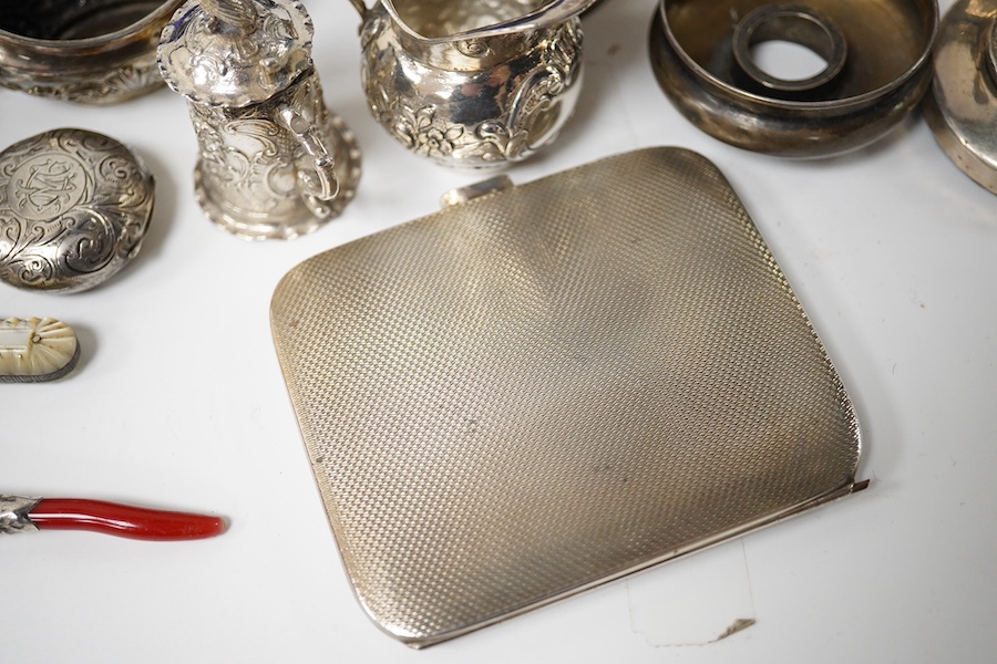 A collection of mainly small silver items including a George V posy vase, mother of pearl handled fruit knife, sovereign case, cream jug, tortoiseshell and silver trinket box (a.f.), continental miniature white metal tan